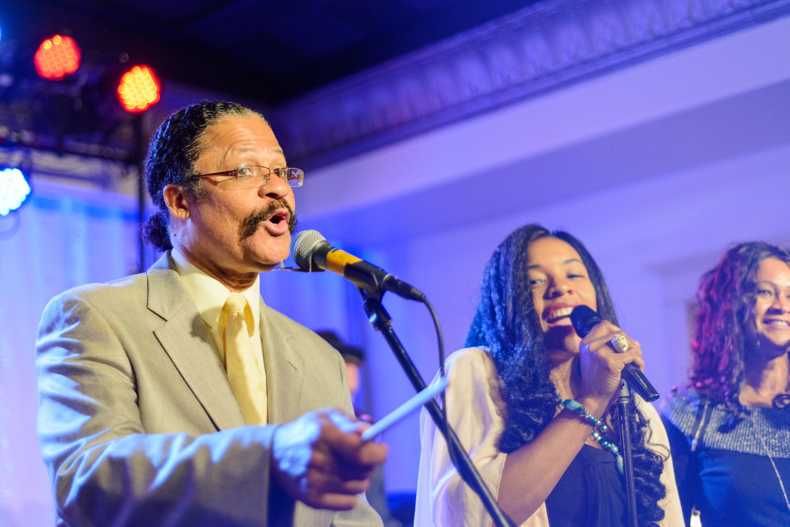 Guy at the mic with 2 other singers